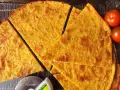 Fetta di cecina dorata, croccante e profumata, pronta per essere gustata. Una deliziosa cecina ricetta da provare subito!